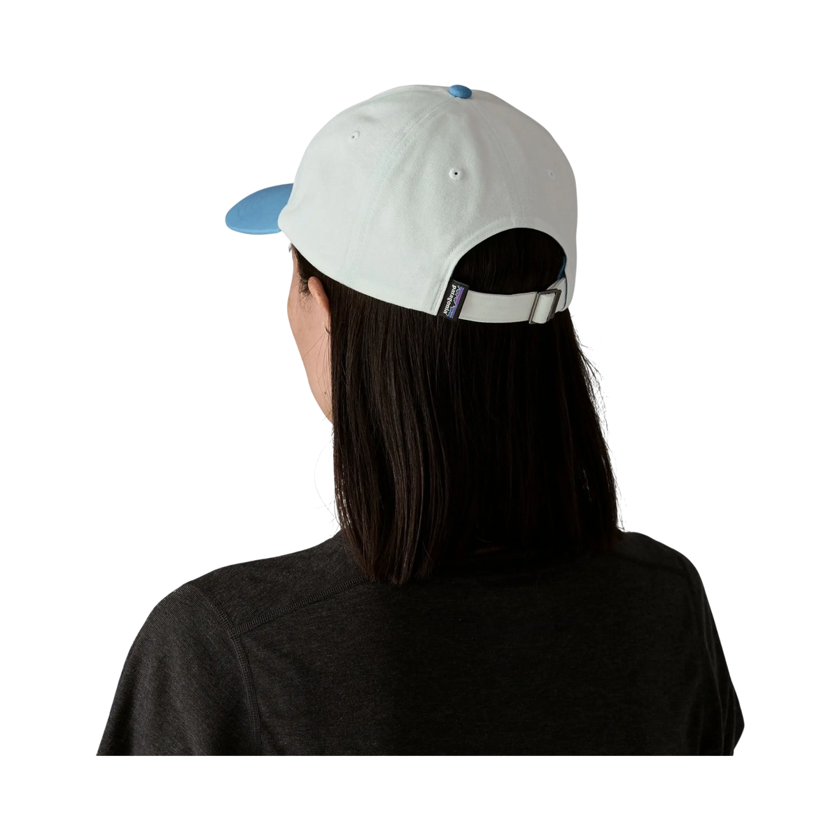 Rear view of the Patagonia P-6 Label Trad Cap blue cap worn by a woman, Surfshop - Shapers Club House