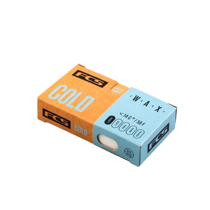 Shapers-Club- La boîte rectangulaire FCS - Wax - Cold présente une superposition bleue sur le côté droit sur laquelle est écrit « WAX » et indique la plage de température. L'emballage partiellement ouvert révèle la cire blanche à l'intérieur, avec la marque FCS bien visible affichée dessus. -surfshop-surfboard