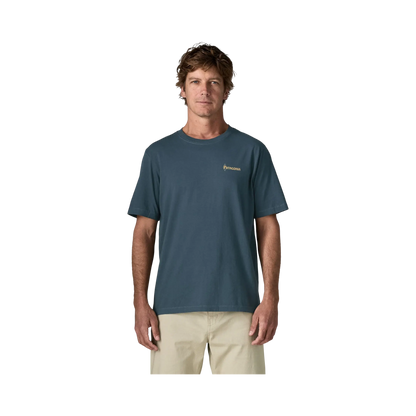 Man wearing a blue Patagonia cotton t-shirt with a logo on the chest, sold by Surfshop - Shapers Club House