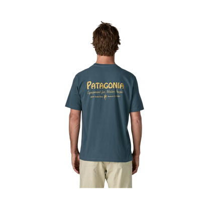 Blue Patagonia Water People Banner T-shirt worn by a man, seen from behind with a graphic logo on the back