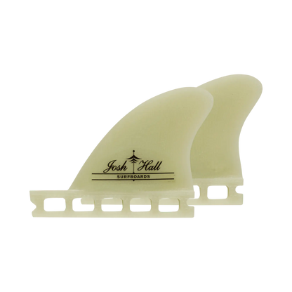 Shapers-Club- fins Two translucent surfboards elegantly display the Josh Hall Surfboards logo, with a Single Tab design, on a solid green background. Product: Josh Hall SB (Single Tab). -surfshop-surfboard