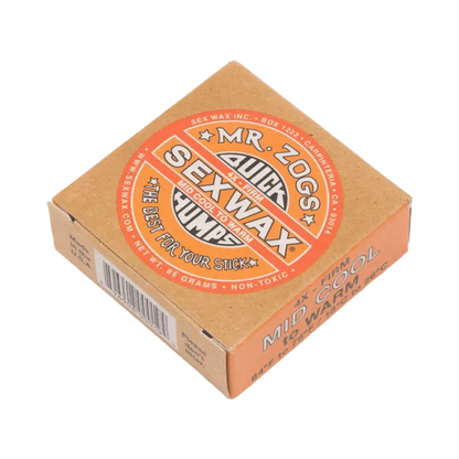 Shapers-Club- The image shows an orange box of 85 g of Sexwax by Mr. Zog, labeled "Quick Humps", "Warm Tropical" and "The Best For Your Stick", designed for surfboards in moderately cool to warm conditions. -surfshop-surfboard