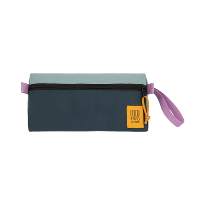 Shapers-Club- The TOPO toiletry bag features a refined rectangular shape with a black zipper and a chic pink drawstring. The top half is lavender green while the bottom half is teal blue. A yellow square patch with gold lettering decorates the lower right corner, adding an elegant touch to this functional accessory. -surfshop-surfboard